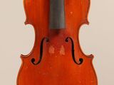 an old violin with a bow hanging from it ' s back