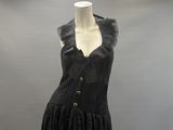black dress with ruffles and gold buttons on a mannequin