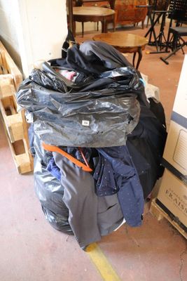 a pile of luggage sitting on top of a pile of boxes