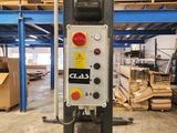 an image of a machine in a warehouse with pallets in the background