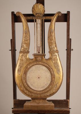 a clock that is sitting on a stand in the room