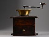 a coffee grinder sitting on top of a wooden table
