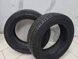 two tires are sitting on a tile floor in a bathroom