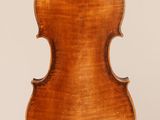 an antique violin with a wooden back and bow