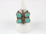 a close up of a ring with turquoise stones on it