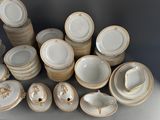 a lot of plates and cups that are sitting on a table