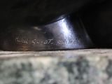 a close up of a metal object on a marble surface