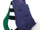 three pairs of men ' s socks with black, white, and green stripes