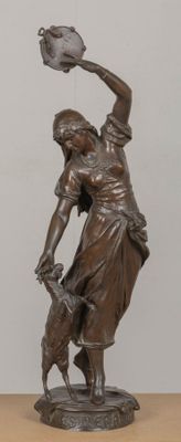 bronze statue of a woman holding a bowl and a dog on a table
