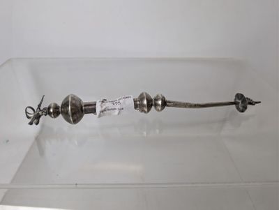 a silver object on display in a glass case