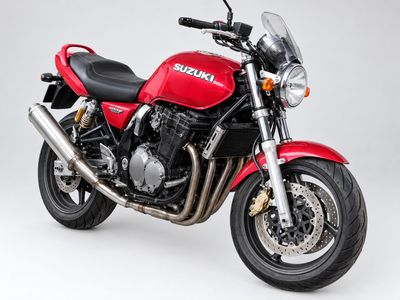 the red motorcycle is parked against a white background