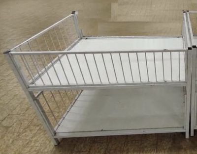 a small metal cage with a door on top of it