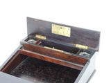 a small wooden box with a metal latch on top of it