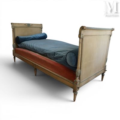 a bed that has a blue blanket on top of it