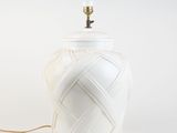a white lamp that is on a white table