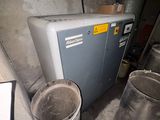 a small air conditioner sitting in the corner of a room