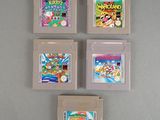 four nintendo game cartridges sitting on top of a table next to each other