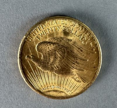 a close up of a gold coin on a white surface