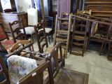 many wooden chairs in a room with a piano in the background