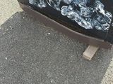 a black and yellow trash can sitting on the side of the road
