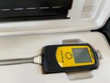 someone is using a thermometer to measure the temperature of a cooler