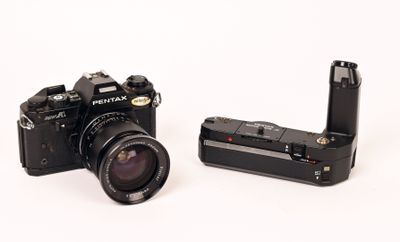 two cameras that are sitting side by side on a white surface