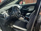 the interior of a car with the door open and the driver ' s seat up