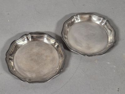 pair of silver plated dishes on a table