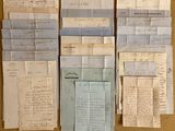 several old papers are stacked on top of each other on a table