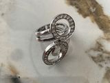a picture of a diamond ring sitting on a marble surface