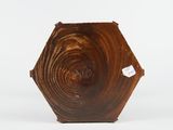 a brown vase that has a hole in the middle of it