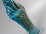 an image of a blue statue of a hand on a clear stand