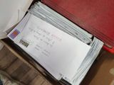 a box full of mail sitting on top of a table