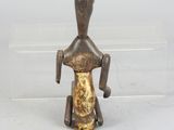 bronze figurine of a woman with a bird on her head