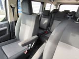 a seat in the back of a van that has two rows of seats