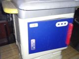 a blue and white cooler sitting on a wooden table