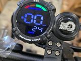 a digital clock on the handlebar of a bike