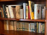 a book shelf with many books on it in a room