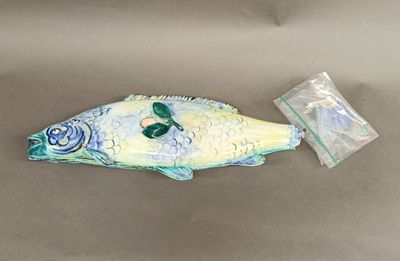 a fish shaped object on a table next to a plastic bag