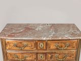 a marble top chest of drawers with brass handles