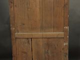 an old wooden cabinet with two doors on top of it