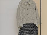 an image of a coat and skirt hanging on a rack