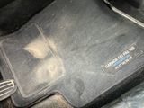 a close up of a car ' s floor mat with a whisk on it