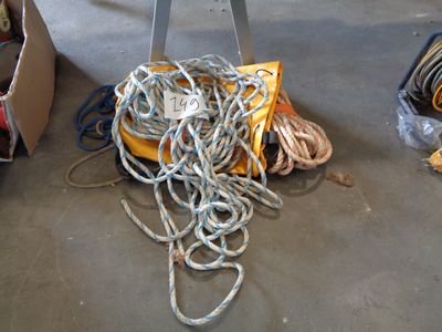 a pile of rope sitting on the floor next to a table