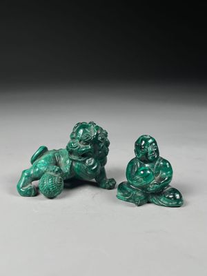 a pair of green jade figurines of a seated man and a seated woman