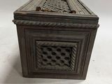 an old wooden box with a decorative design on the lid