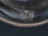 a silver plate with a coat of arms on it