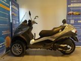 a scooter that is parked in a showroom