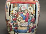 a large vase with a painting of people on it
