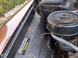 an old car engine with the hood up and the hood down